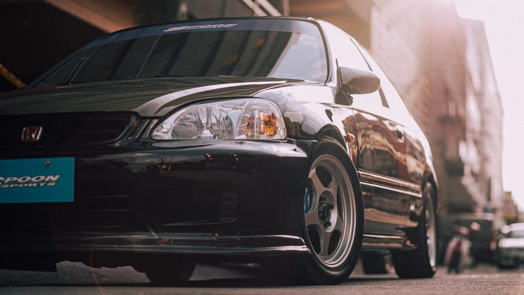 Customer build — a tuned Civic Type R parked in the delivery bay with spec sheet on the windshield.